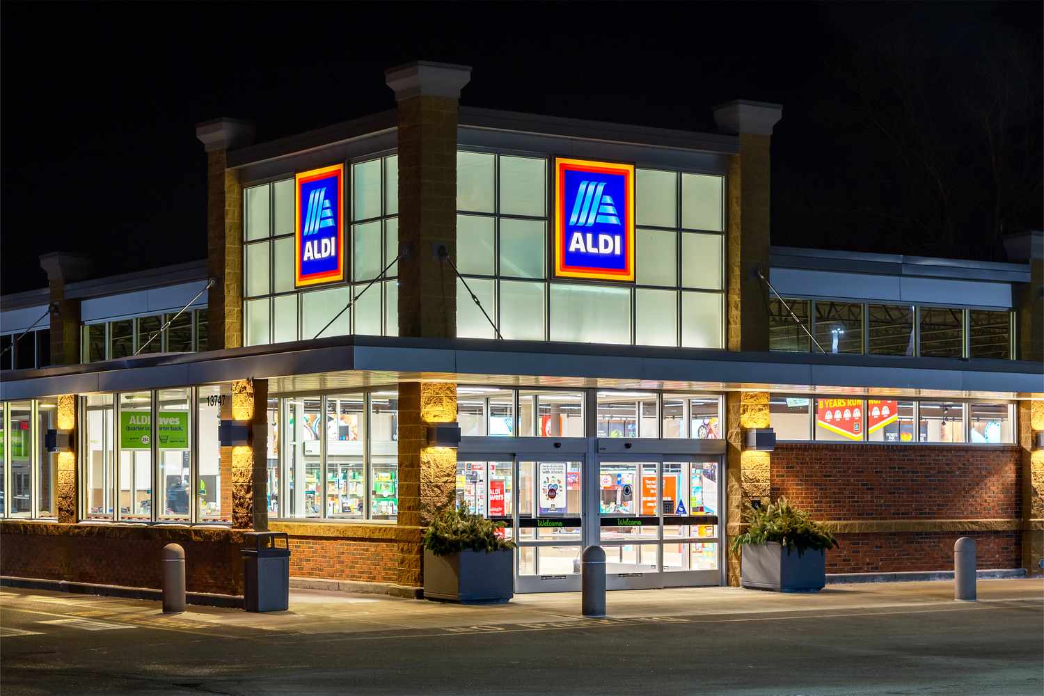 Aldi store illuminated at night front view entrance