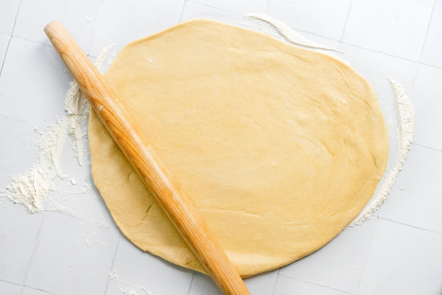 Sufganiyot Dough Rolled Out on a Floured Counter Using a Rolling Pin 