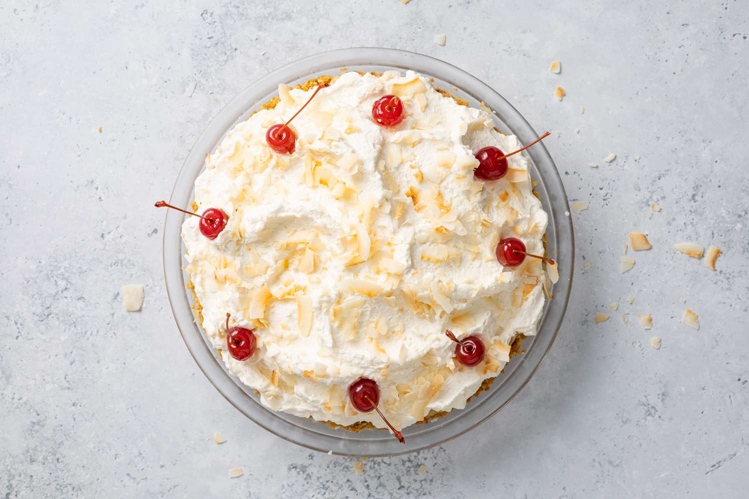 Piña Colada Pie with Toasted Coconuts and Maraschino Cherries