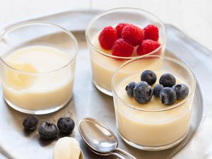 Easy Lemon Pudding in three cups topped with berries