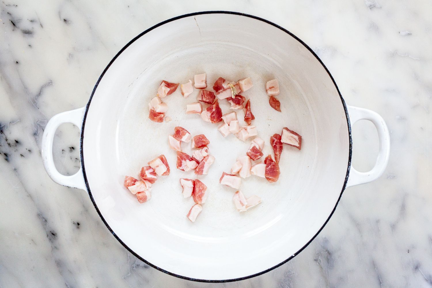 Brown pork in dutch oven for classic tomato sauce