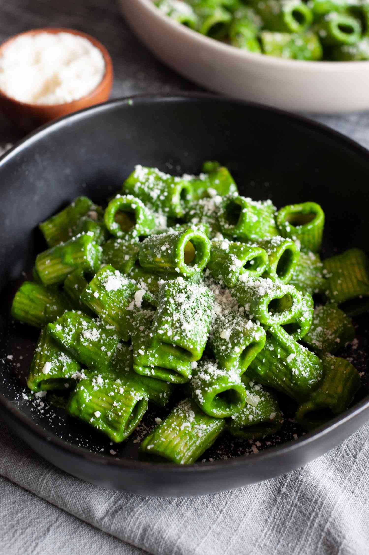 Lemony swiss chard sauce pasta in a black bowl.