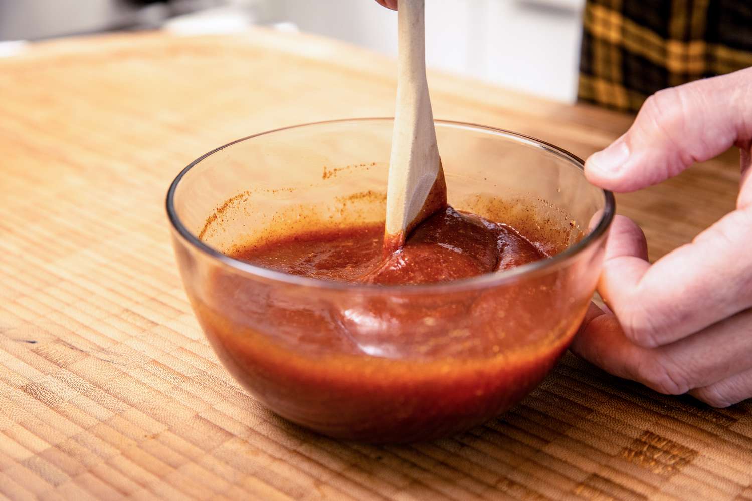 BBQ Sauce Ingredients Mixed Together in a Bowl with a Wooden Spoon for Microwave BBQ Chicken Wings Recipe