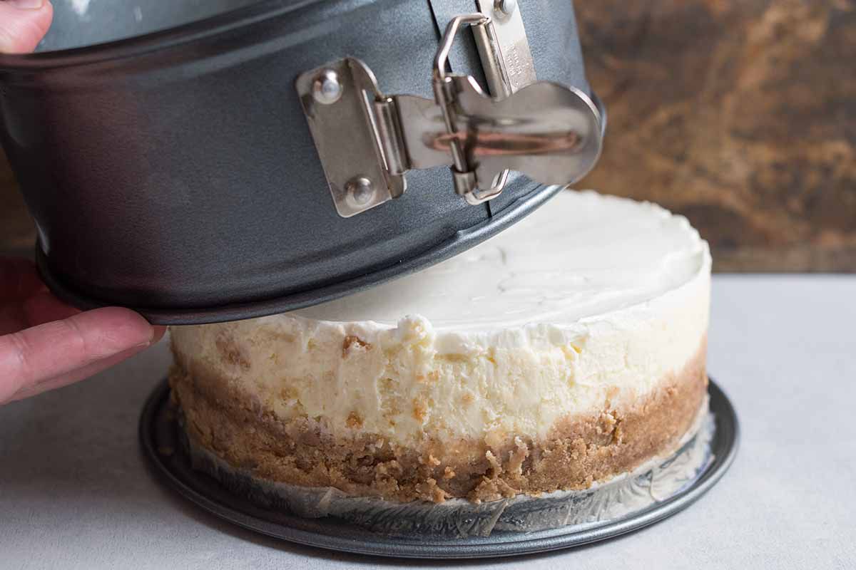 Instant Pot cheesecake being taken out of the springform pan