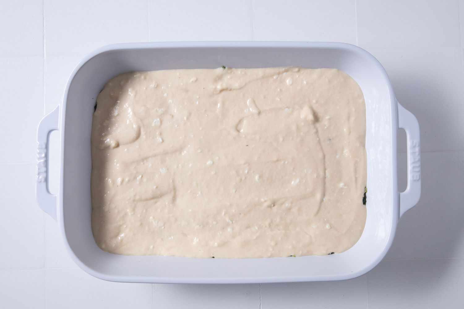 rest of wet batter added on top of the filling in the casserole dish for batsaria recipe