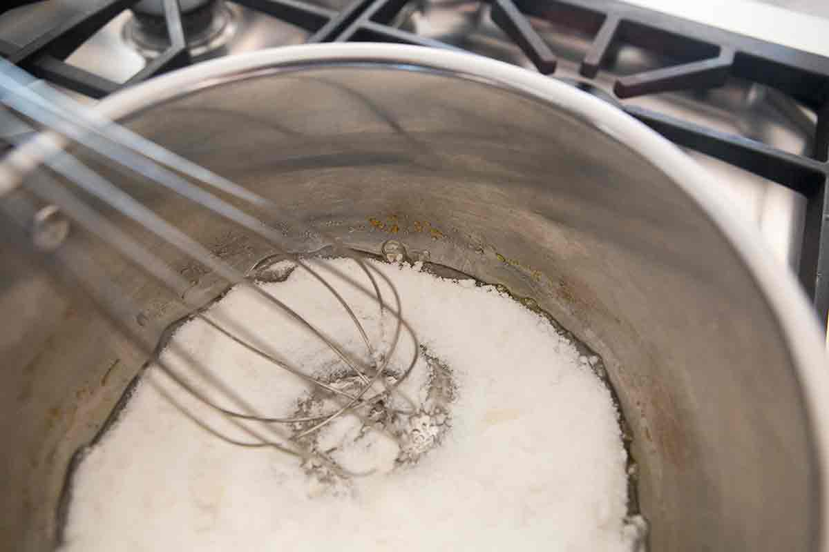 heat sugar in pan with whisk to make caramel sauce