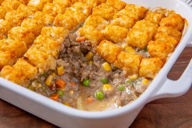 Classic Tater Tot Hotdish in a baking dish with one scoop removed