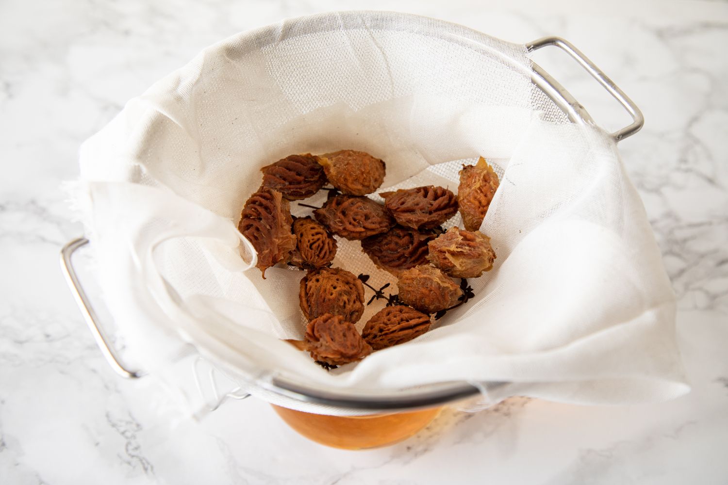 Straining out pits from the infusion for the liqueur 