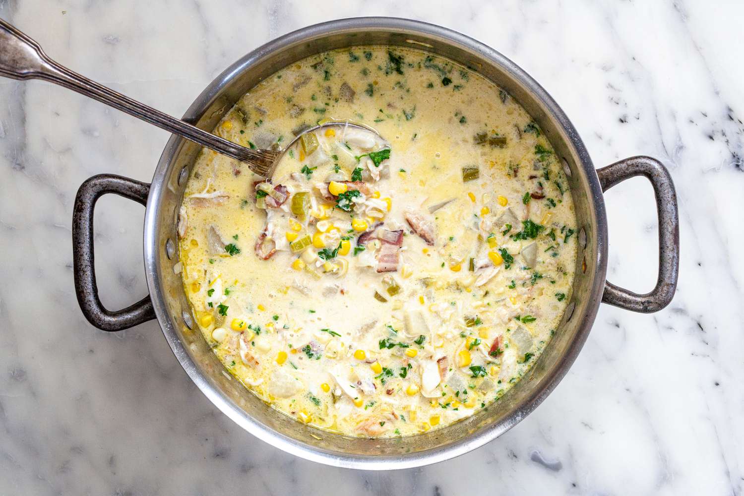 Cream, Parsley, and Lemon Juice Mixed into Pot of Corn and Crab Chowder