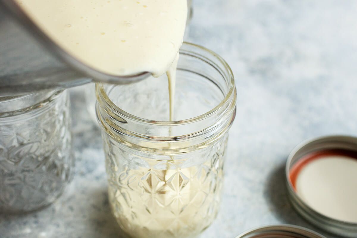 Pouring cheesecake filling in a jar to sous vide