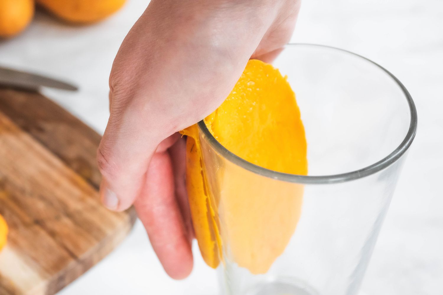 Peel mango with a glass cup