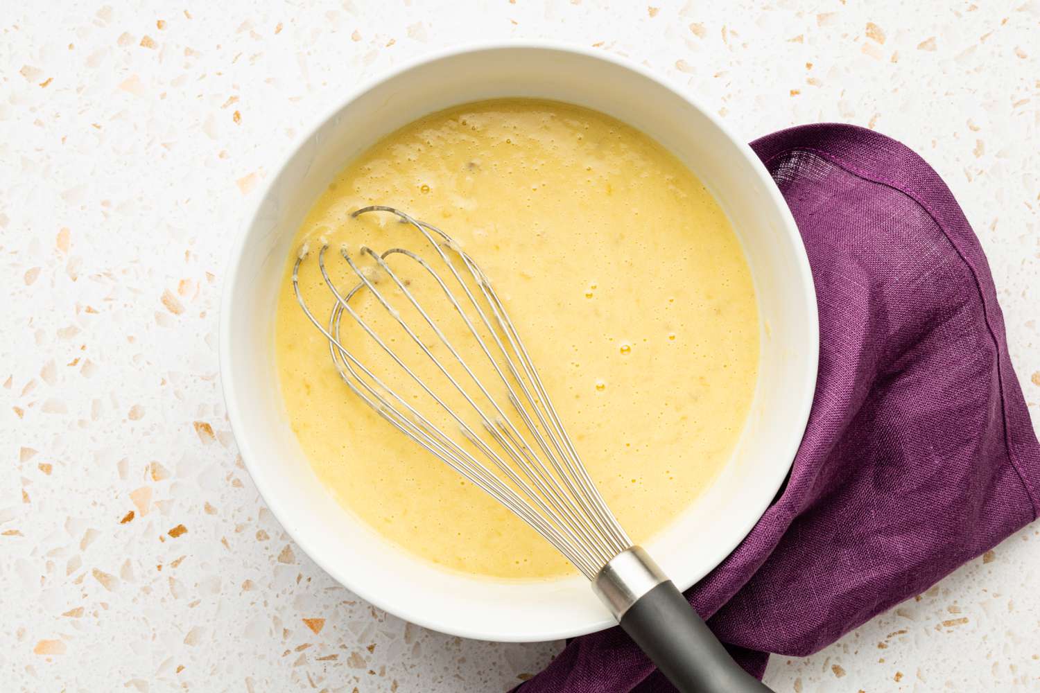 Bowl of Wet Ingredients Whisked Together for Banana Pecan Bread With Caramelized White Chocolate Sorghum Glaze Recipe