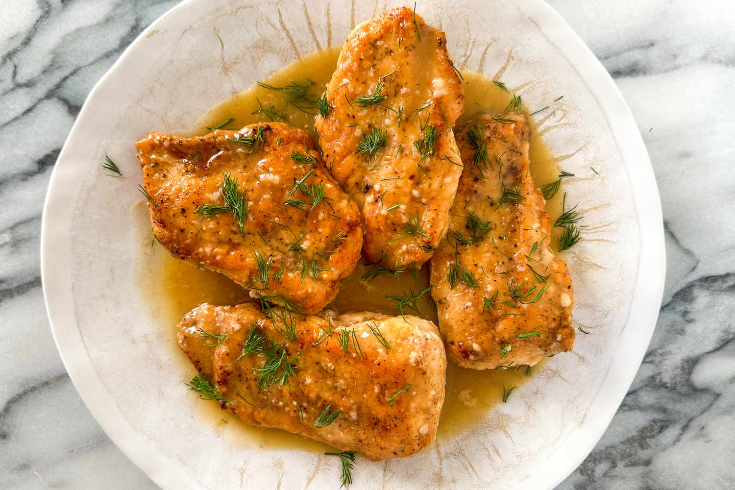lemon chicken with sauce on a plate
