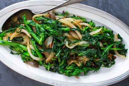 Broccoli Rabe and onions served on a platter.