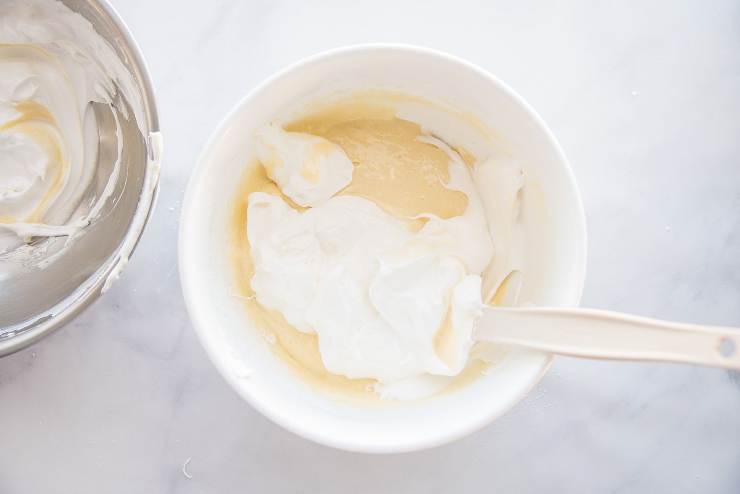 Mixing egg yolks and sugar to make Brazo Gitano (Spanish Roll Cake.