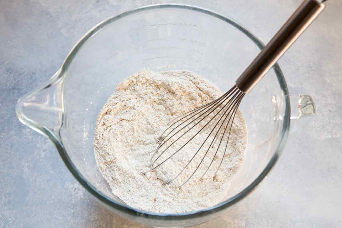 Dry ingredients for hot cross buns in a mixing bowl after mixing
