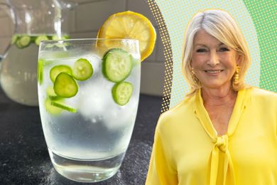 Martha Stewart next to a glass of infused water with lemon and cucumber slices