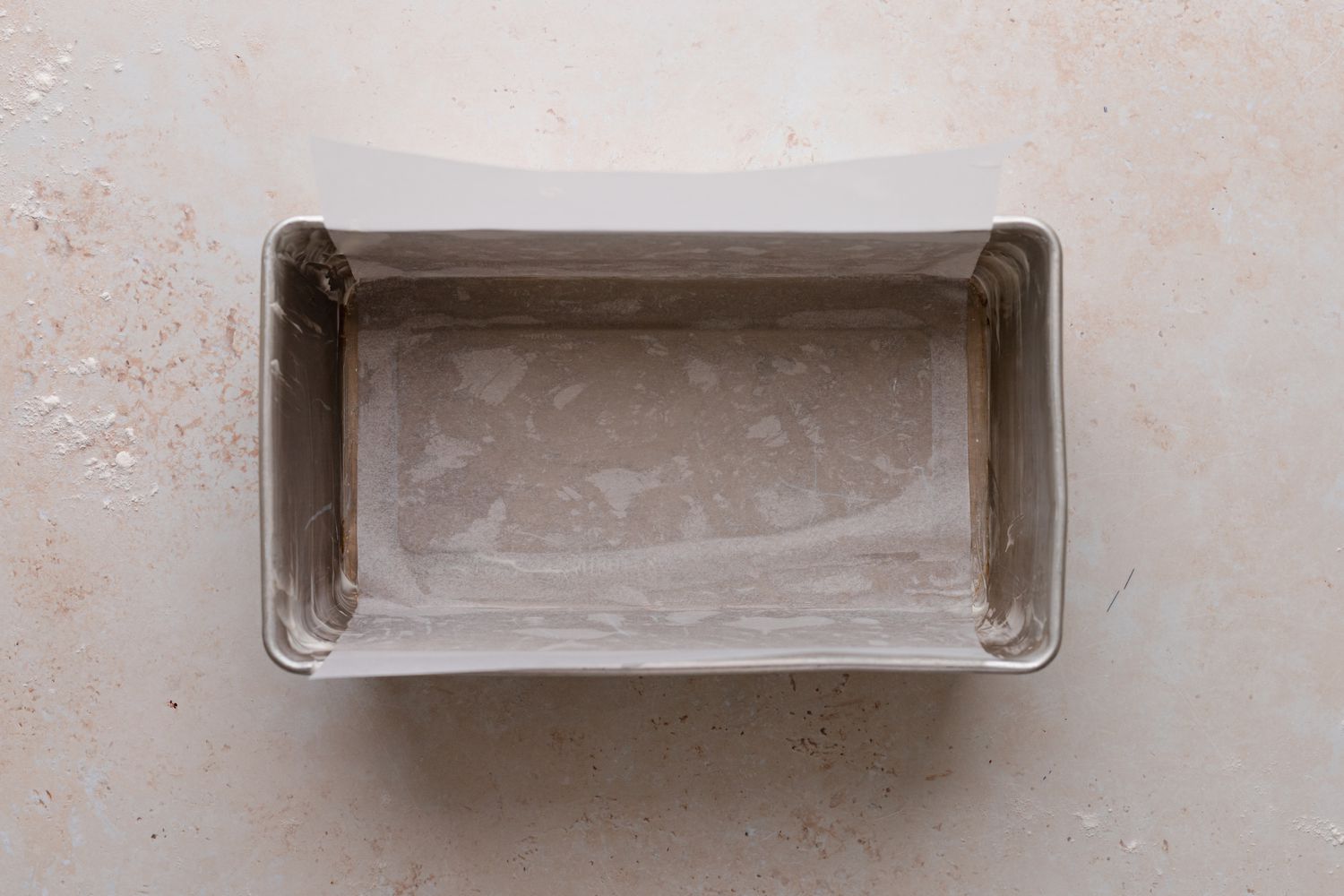 Loaf pan coated with parchment and cooking spray to make chocolate babka.