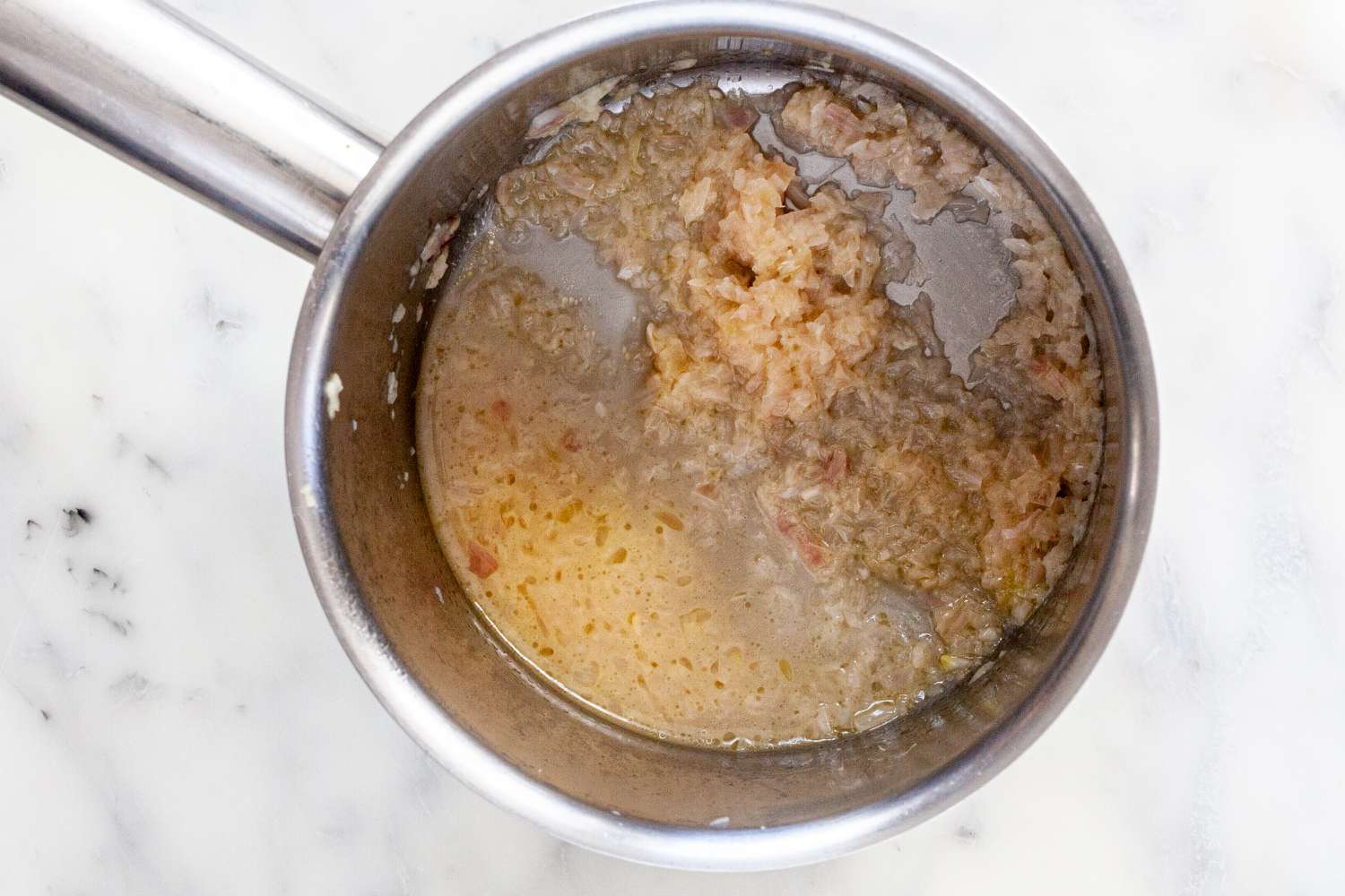 Melted butter, shallots, and white wine for classic buerre blanc sauce