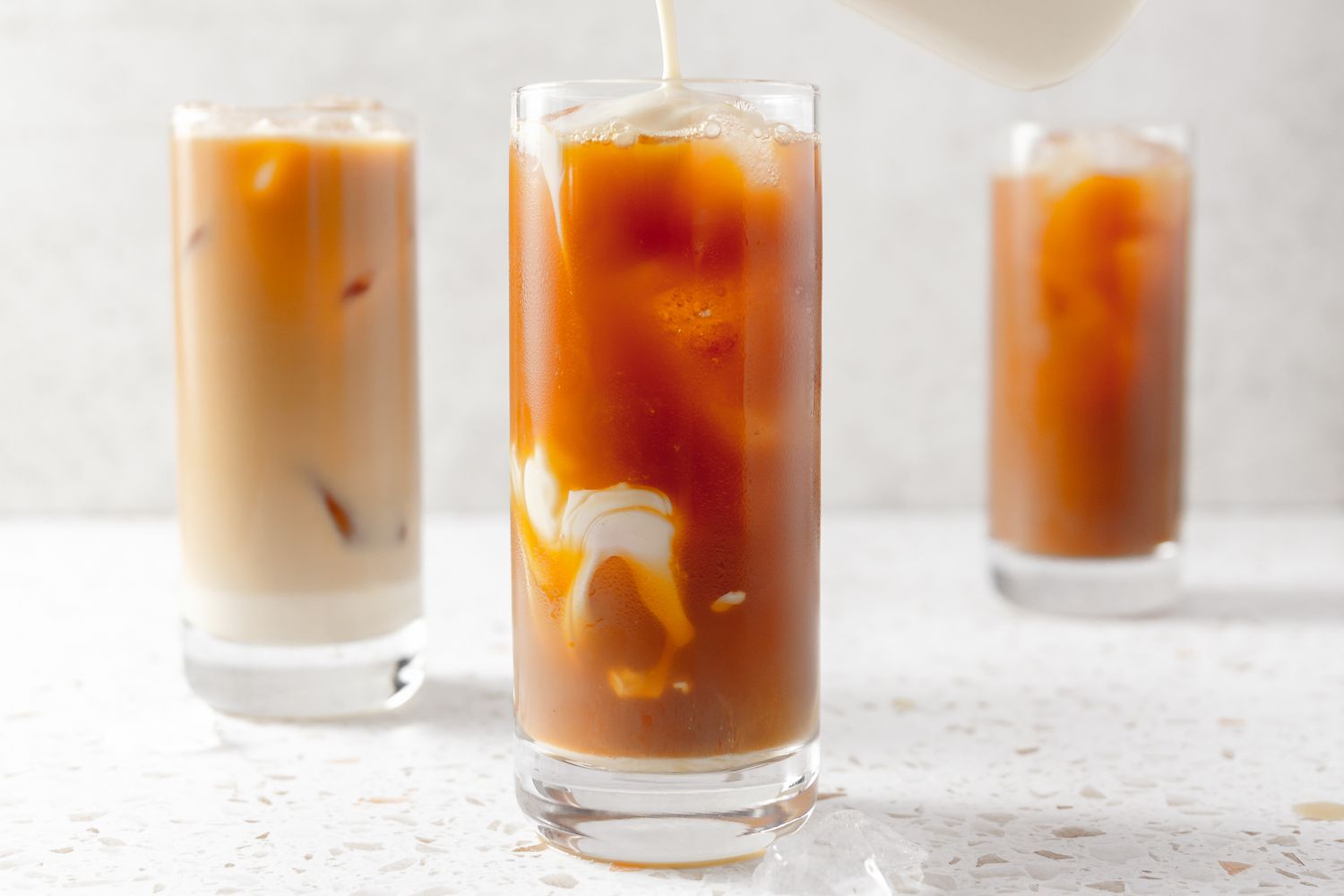 Milk Mixture Poured Into Glass to Make Thai Ice Tea Recipe