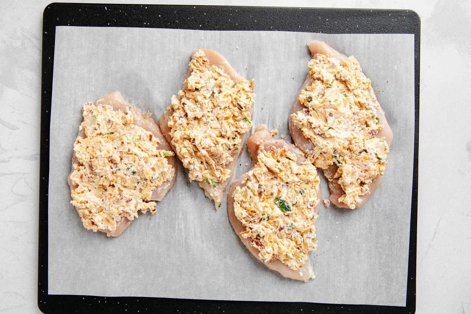 Million dollar chicken on a piece of parchment paper