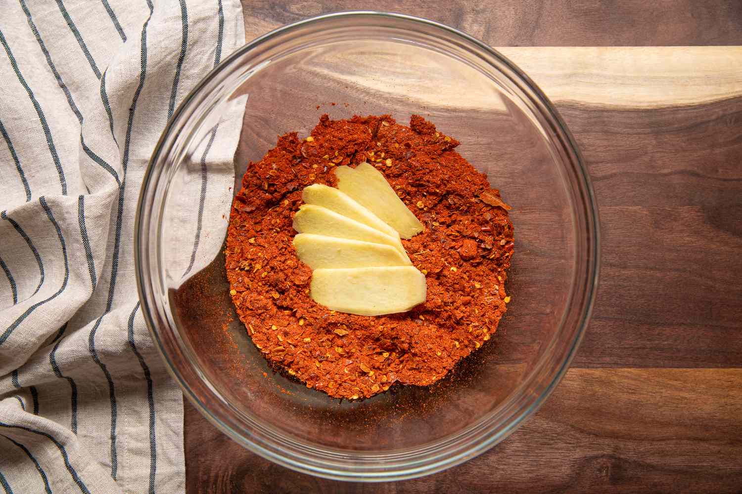 Sliced Ginger in the Bowl With Pepper Mix for Homemade Chili Crisp Recipe