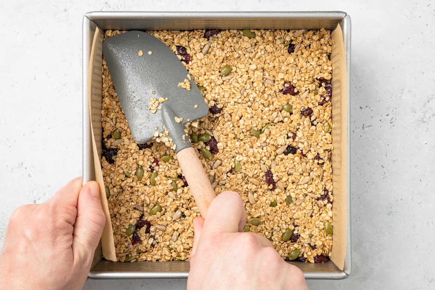 Flapjacks Batter Flattened Into the Baking Pan Using a Rubber Spatula