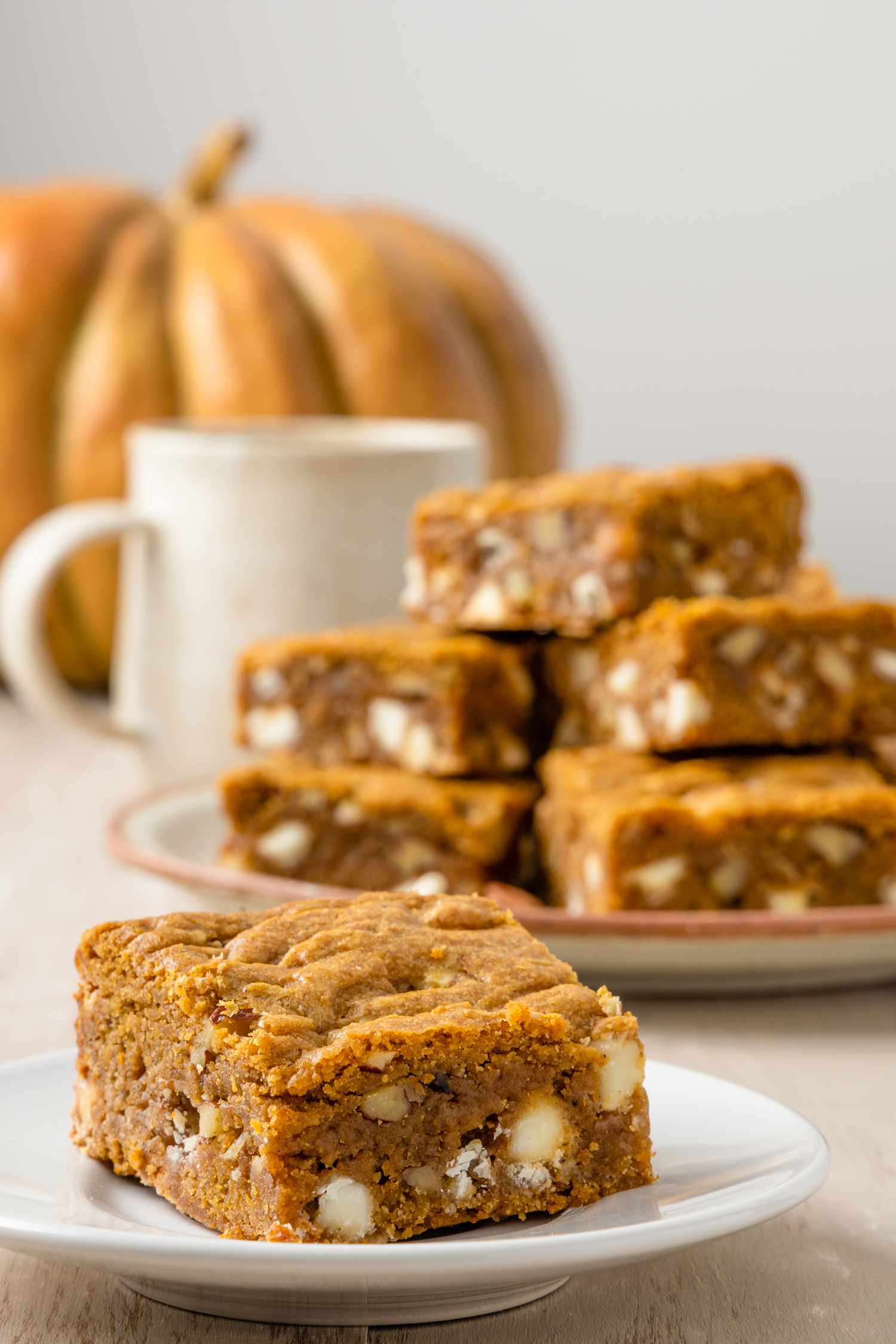 Pumpkin Blondie on a Plate with More in the Background in a Pile on a Plate