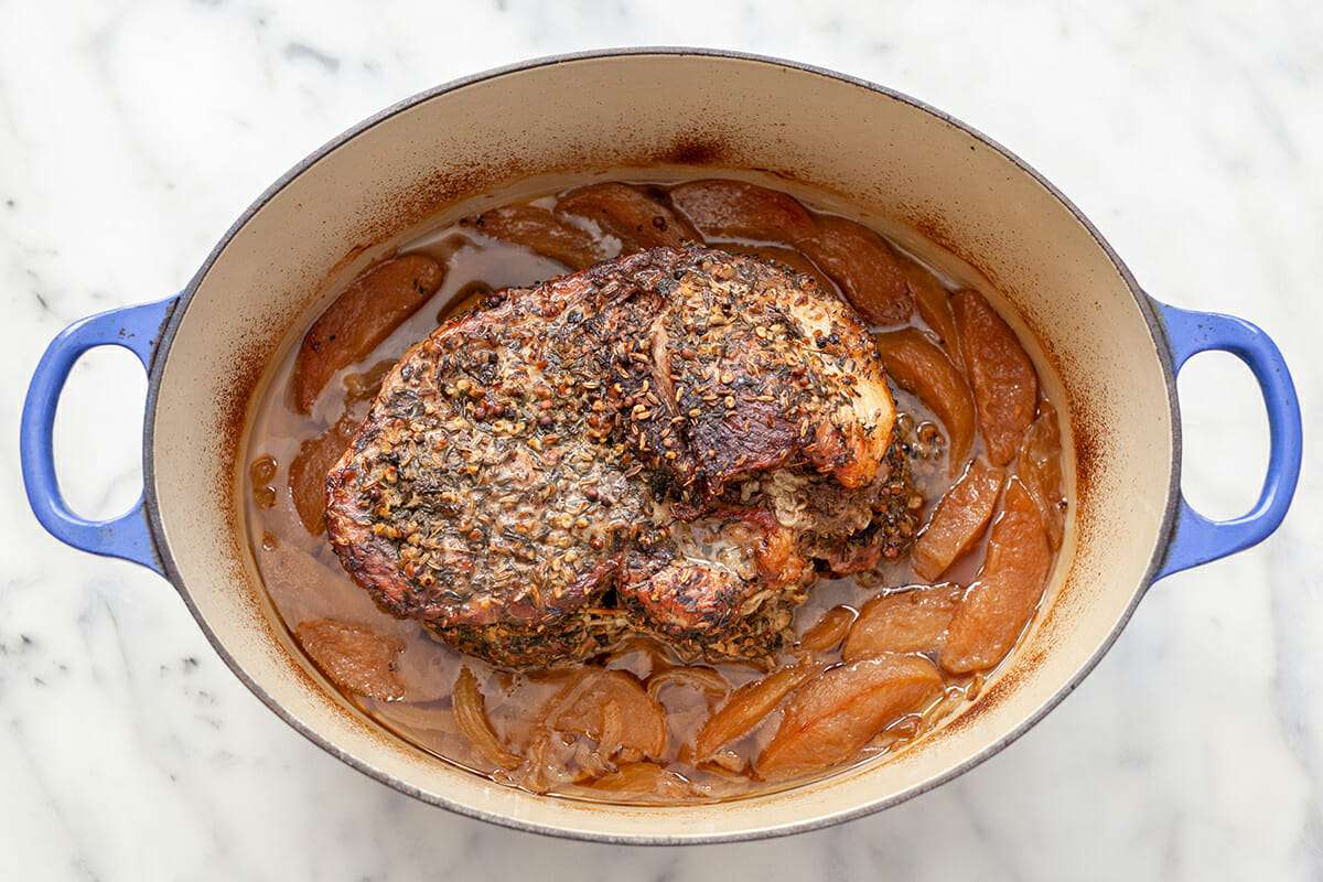 Pork shoulder in oven, cooked in a dutch oven.