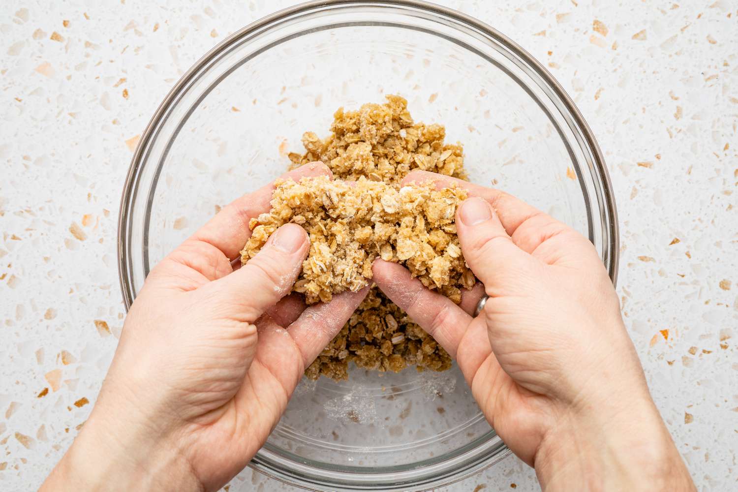 Hands Working Streusel Mixture for Blueberry Muffin Top Recipe