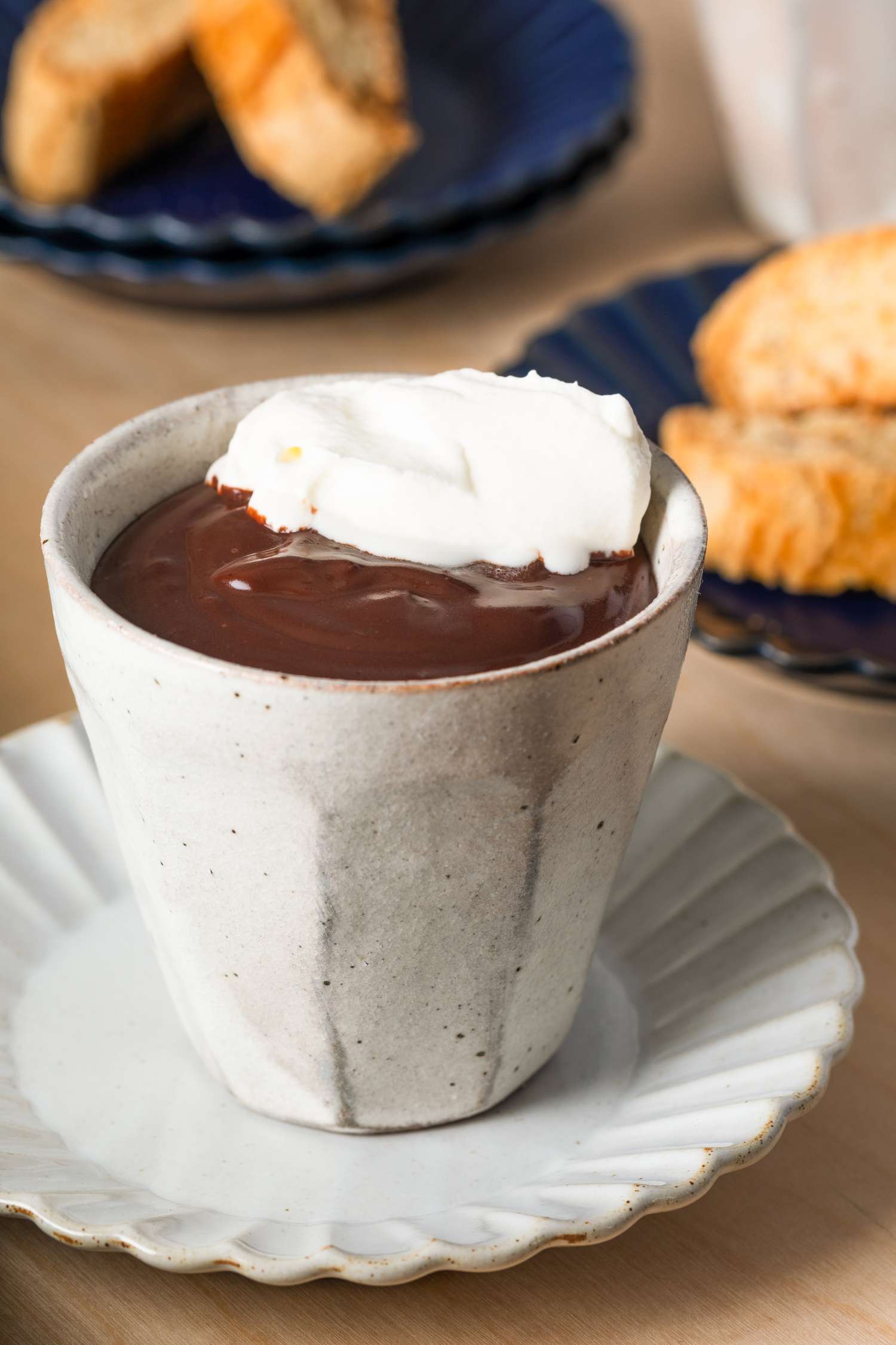 Cioccolato Caldo con Latte (Italian Hot Chocolate) in a small white mug with whipped cream on top