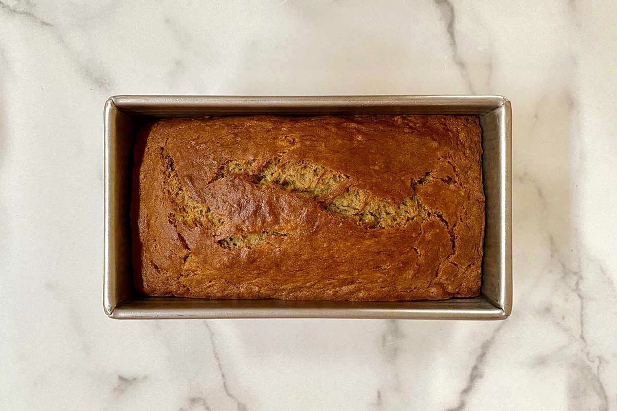 Loaf of the best gluten free banana bread on a marble background.