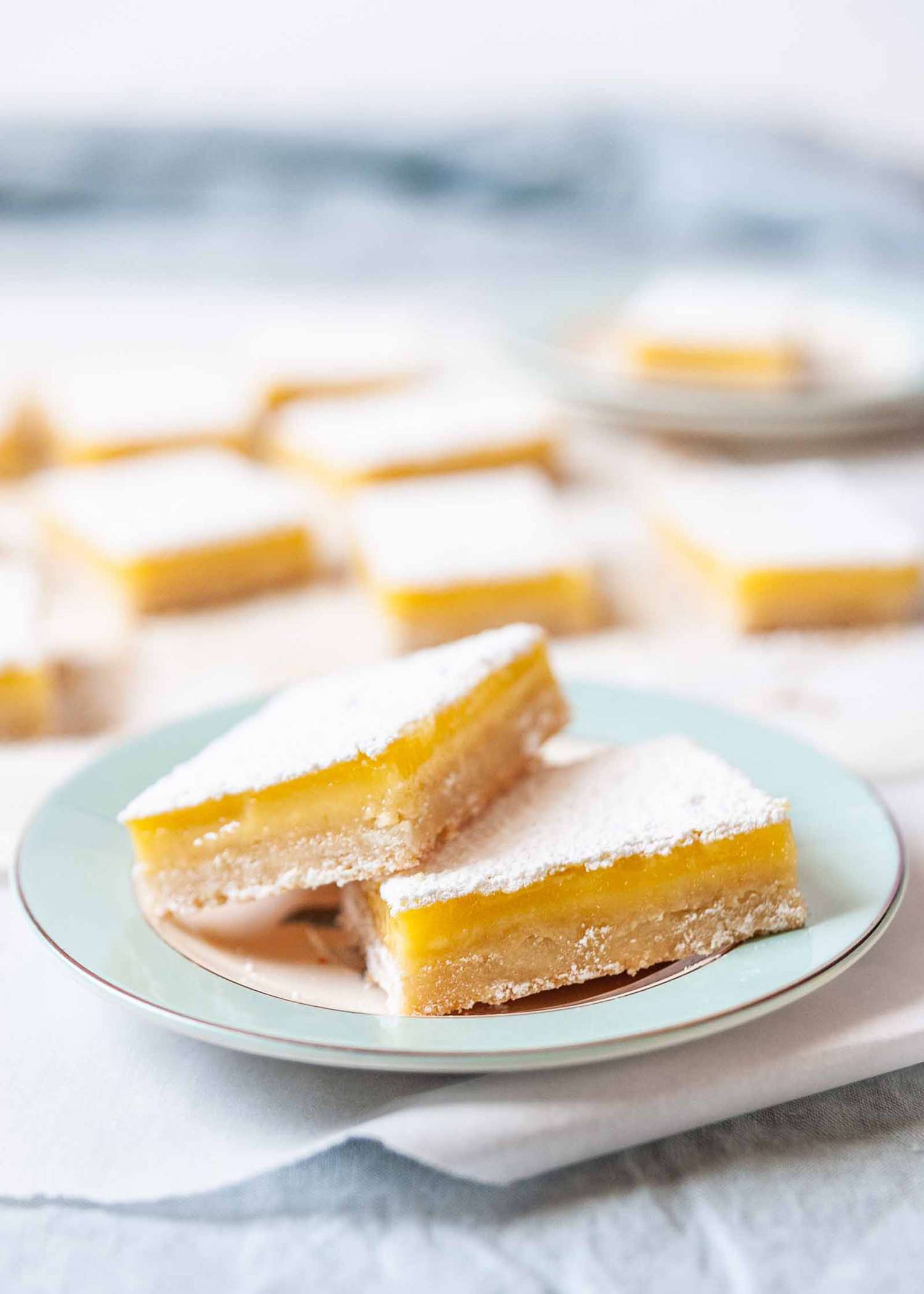 How to Make Lemon Bars - lemon bars on blue plate
