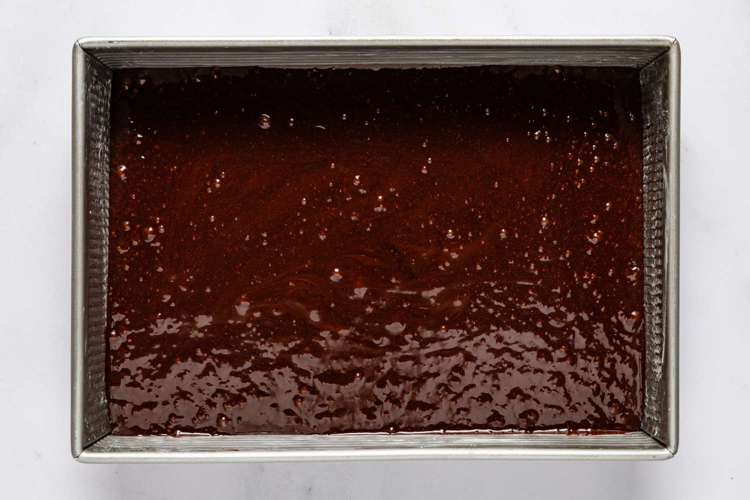devil's food cake batter added to baking pan