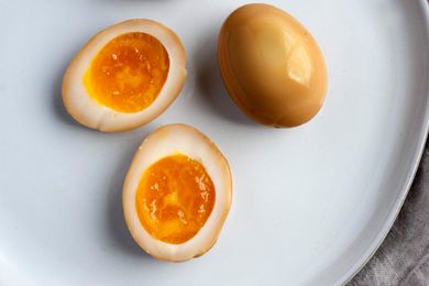 Soy Sauce Eggs on Plate with Two Eggs Cut in Half