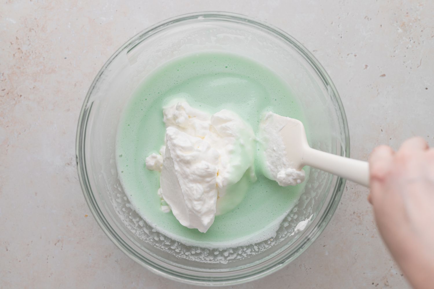 Adding whipped cream to filling for a grasshopper pie recipe.