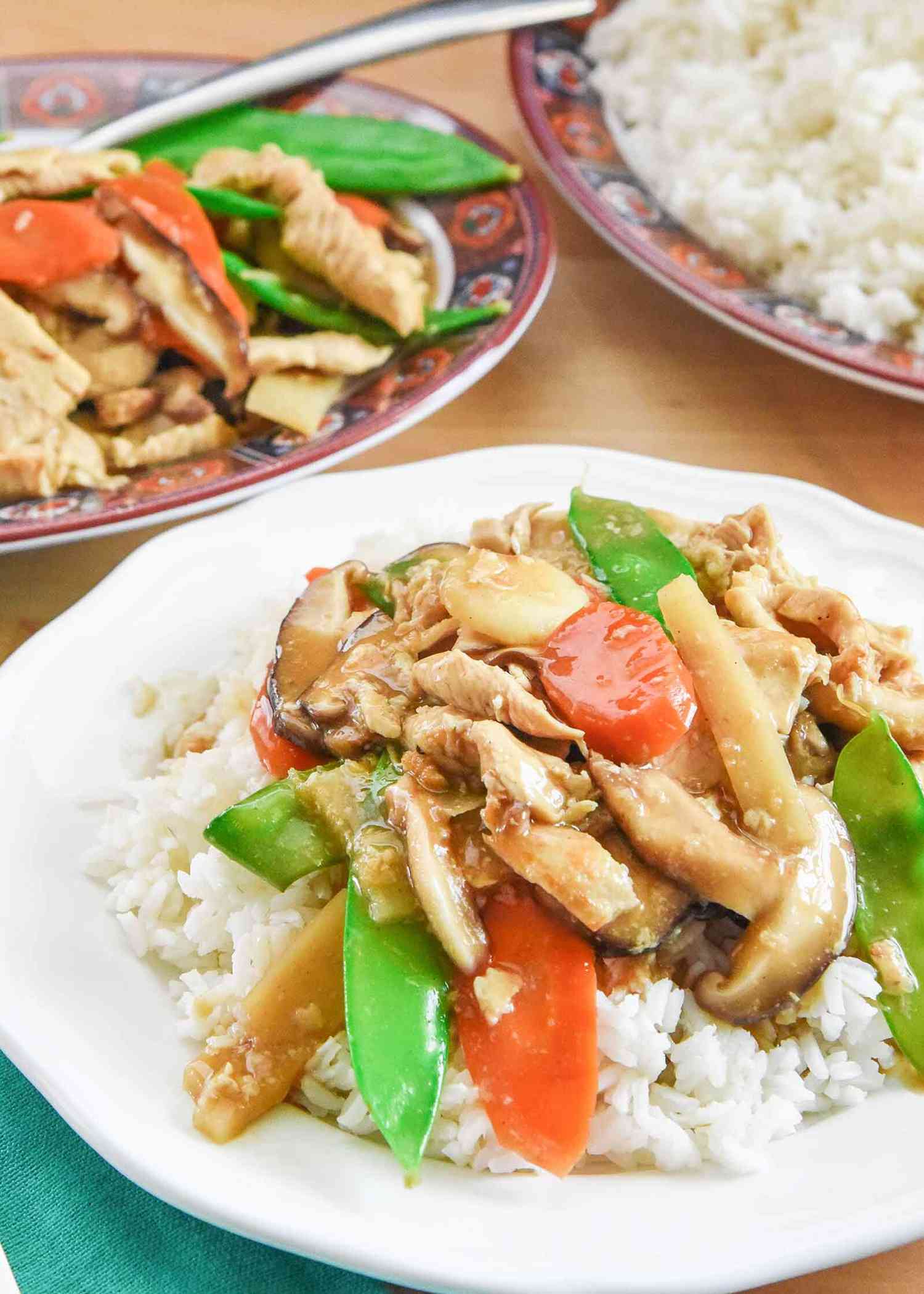 Moo Goo Gai Pan Chinese Food on a white plate with a platter