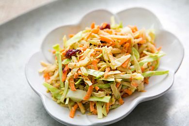 Broccoli Slaw with Cranberry Orange Dressing in a white bowl