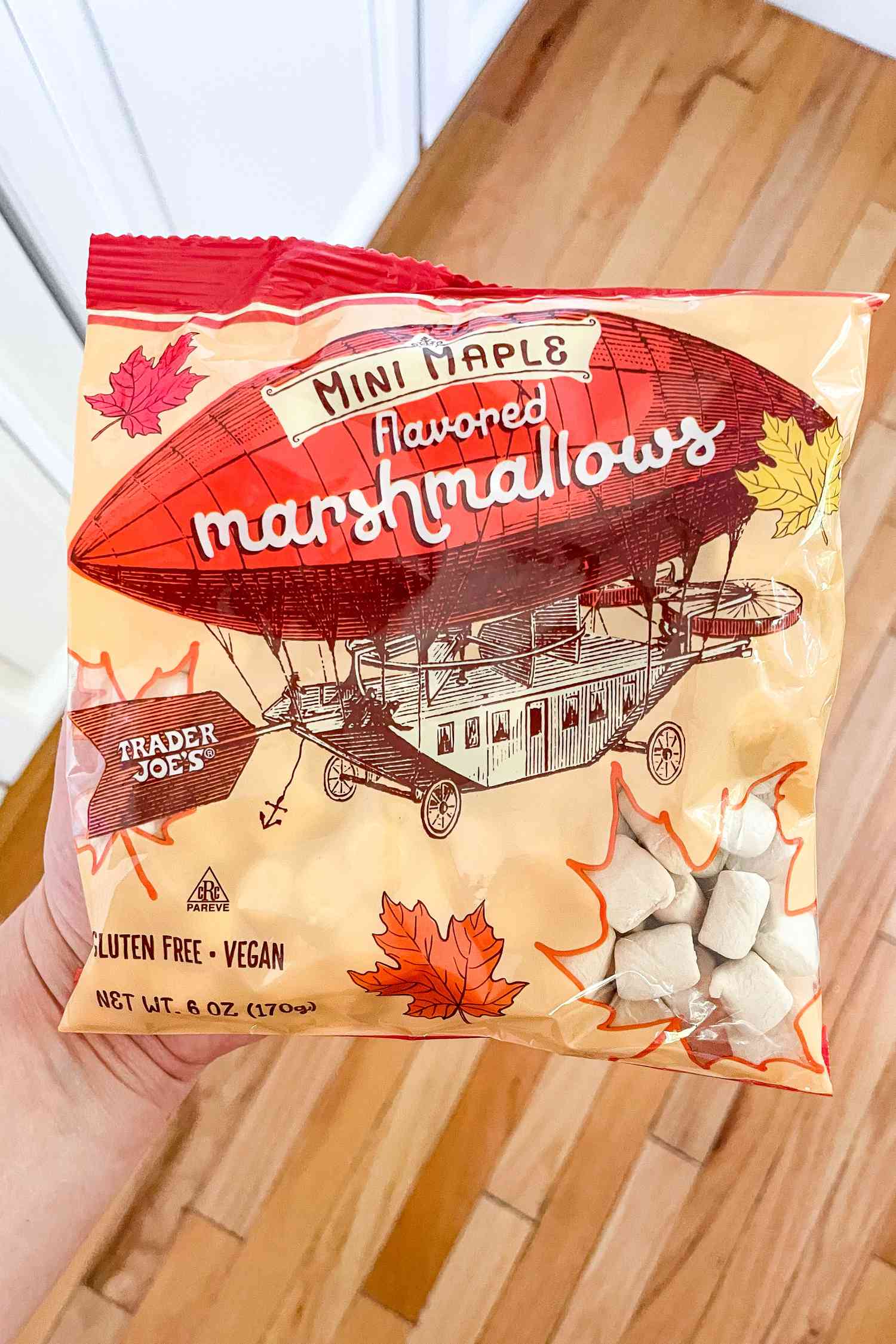 Hand holding a bag of Trader Joe's Mini Maple Flavored Marshmallows