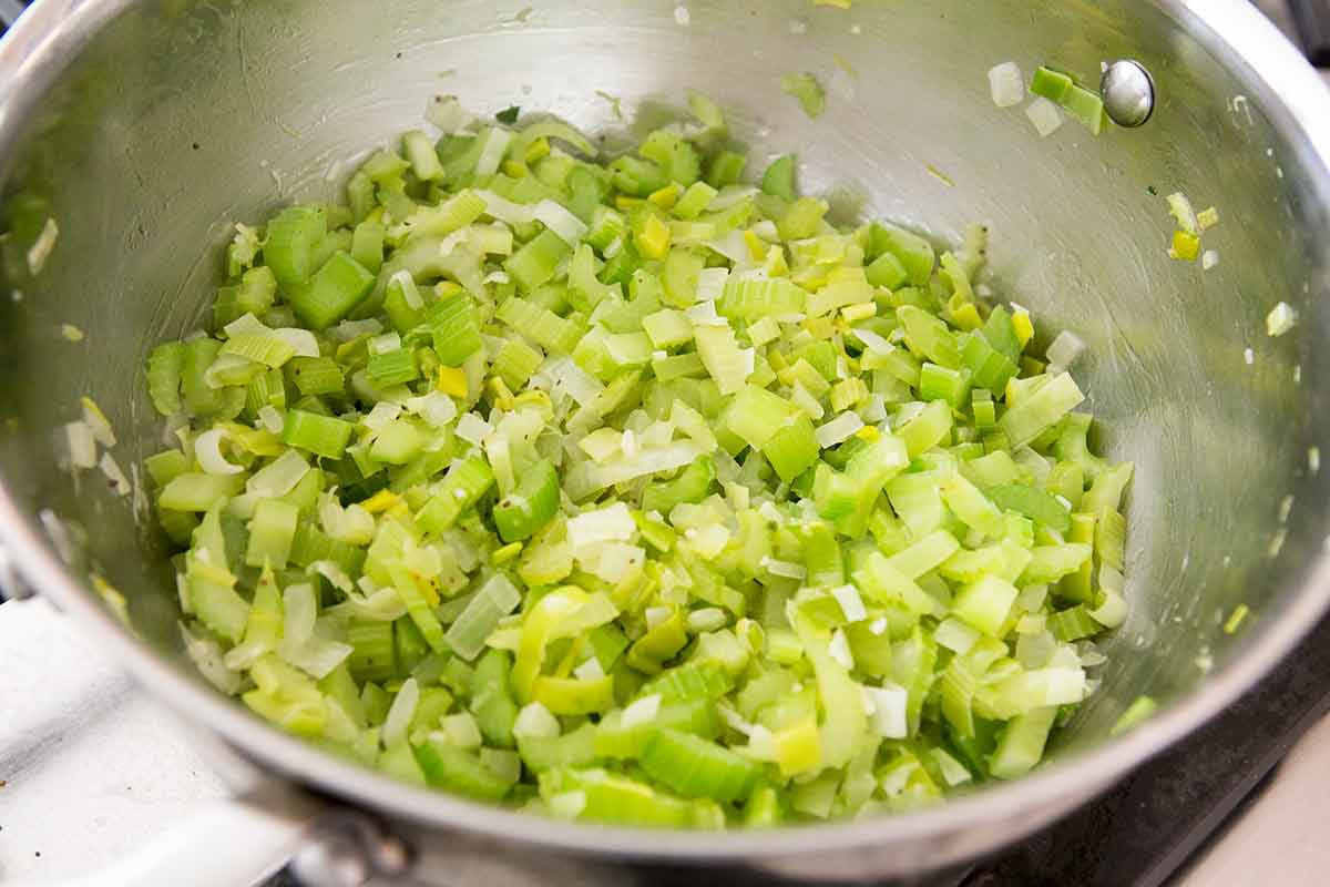 Chopped celery and onions cooking in a pot