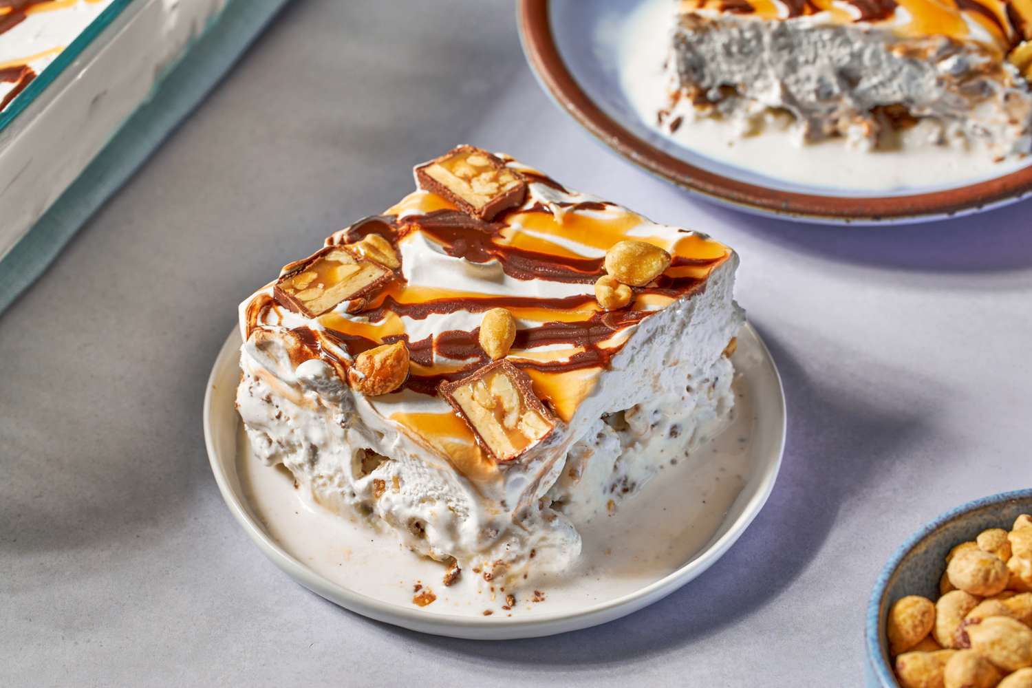 Dessert dish of Snickers ice cream casserole with caramel and chocolate