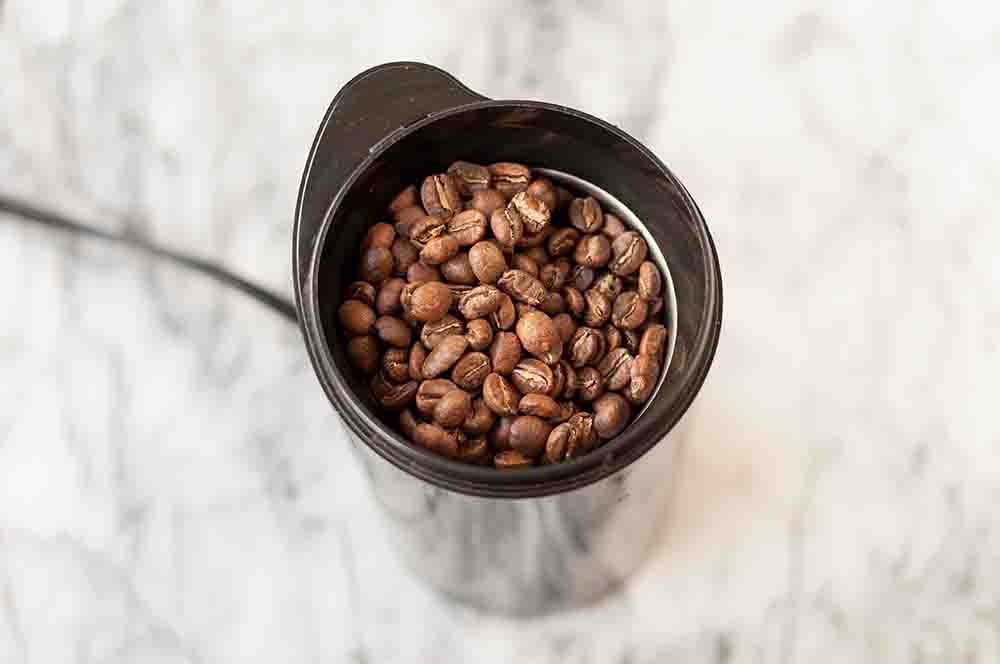 Coffee beans in a grinder