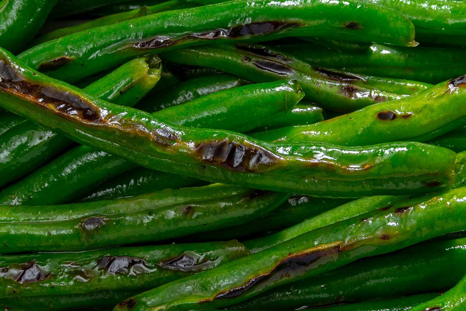 A closeup shot of slightly charred pan fried green beans
