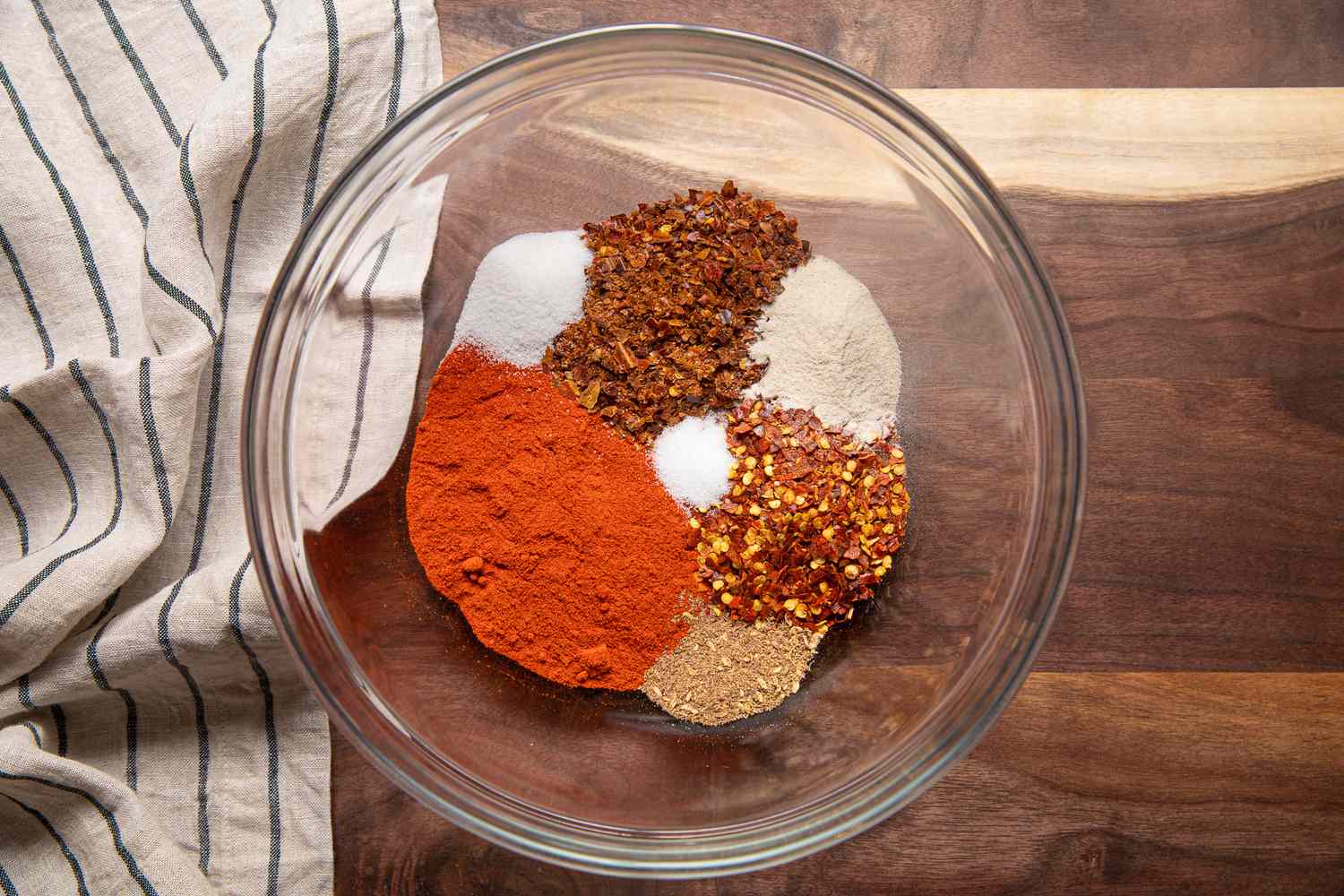 Gochugaru, Red Pepper Flakes, Japones Pepper Flakes, Mushroom Buillon, and Salt in a Bowl for Chili Crisp Recipe