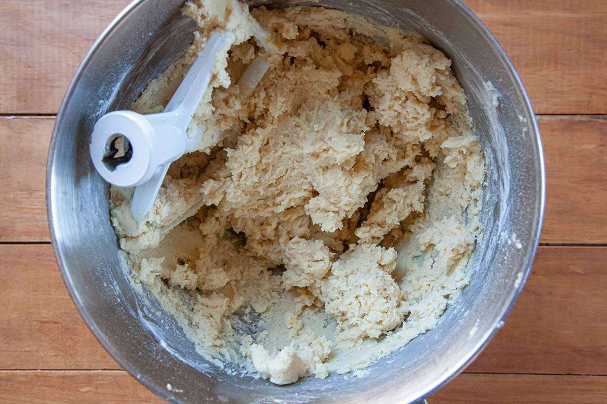 Cookie dough mixed in the bowl of a stand mixer to show how to make Sugar Cookies.