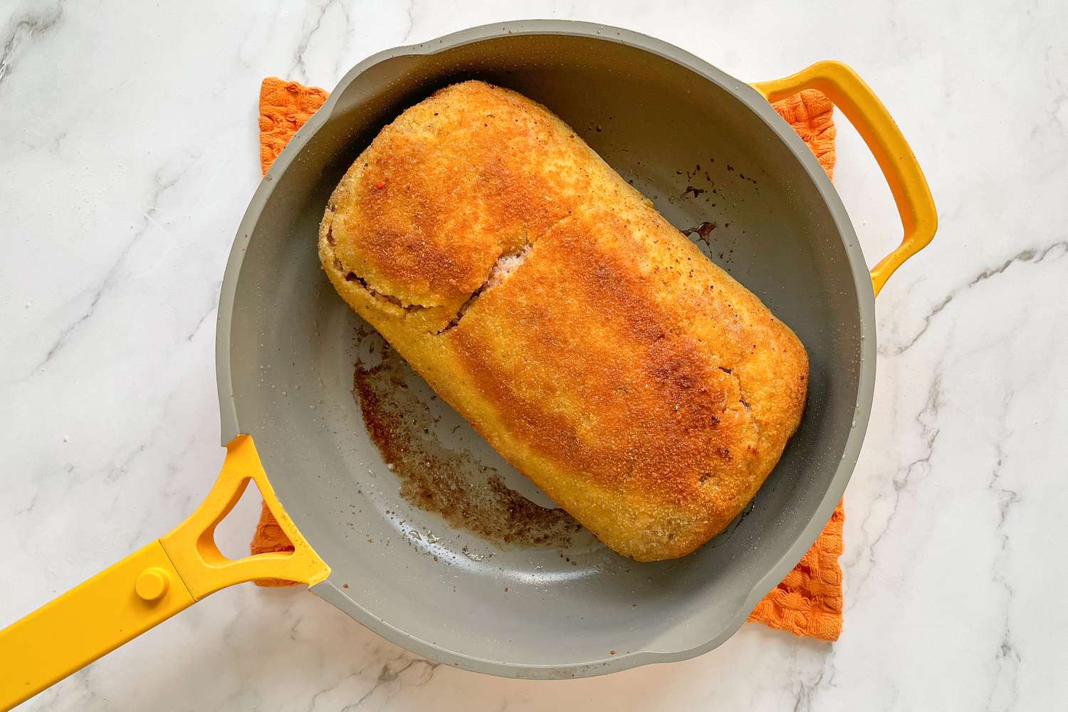 Pulpeta (Cuban Meatloaf) browned in a skillet.