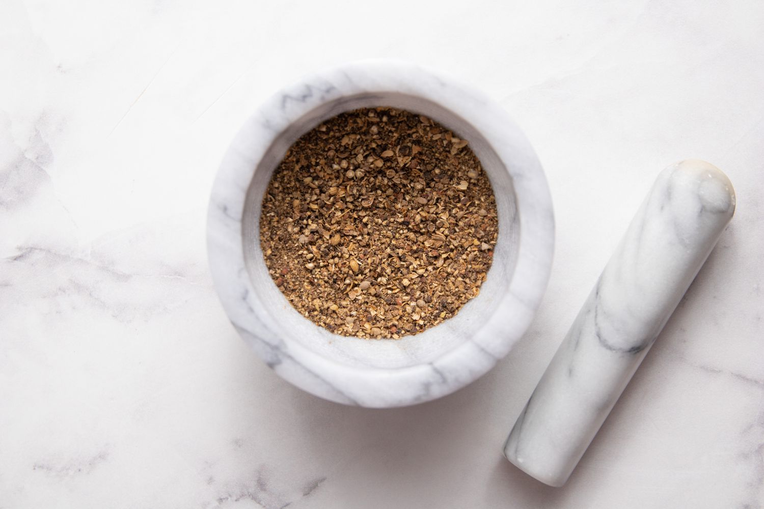 Spices in Mortar and Pestle for Smoked Whole Cauliflower with Spiced Soy Butter and Satay Sauce