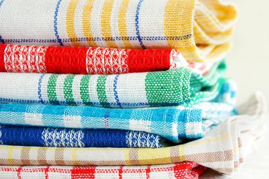 Stack of folded kitchen towels with different patterns