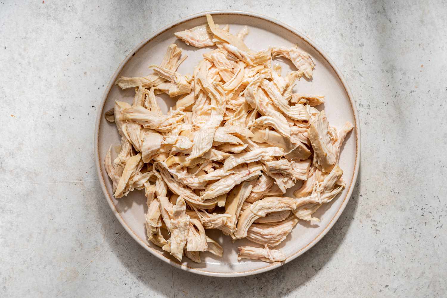 chicken shredded into pieces on a plate for white chicken lasagna soup recipe