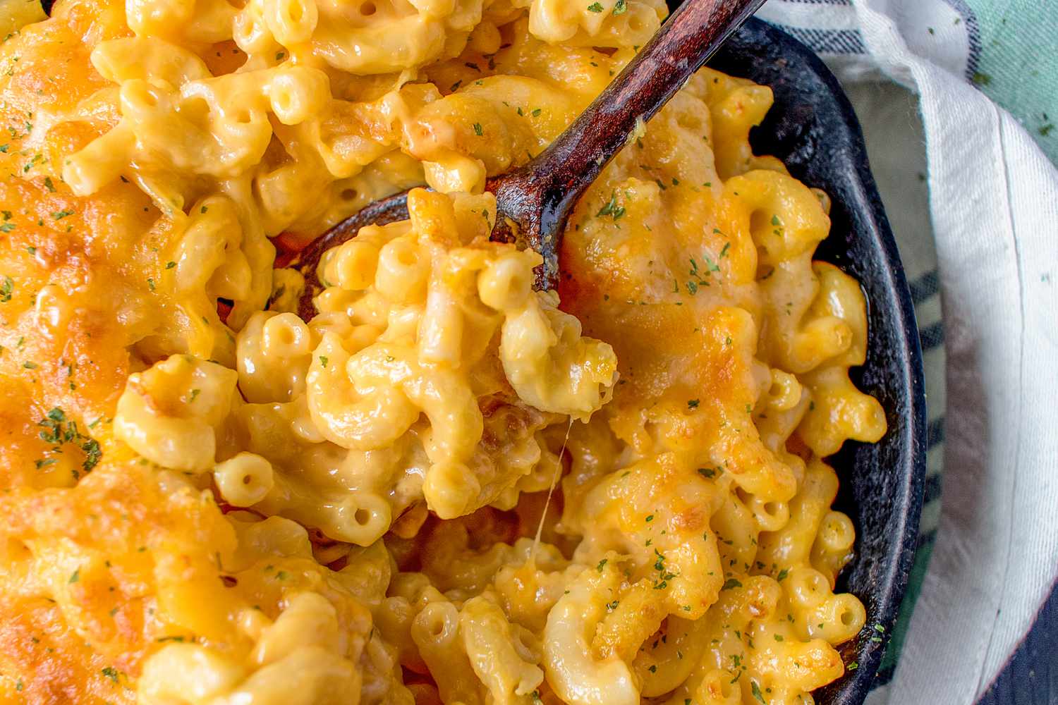 A close-up of a super-cheesy skillet of mac and cheese